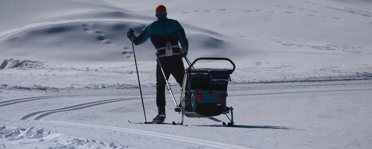 Skier on a groomed track with a cross-country ski boot clipped into the binding
